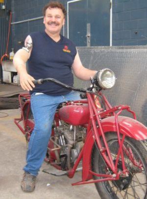 Man with above elbow prosthesis on a motorcycle.